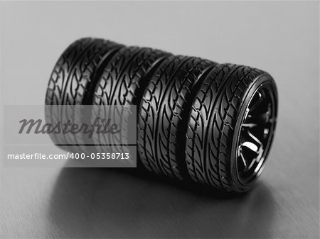 Rubber tyres with sports rims on a silver background