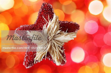 Star Christmas decoration against red blurred background