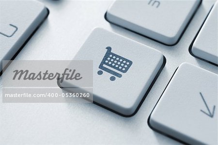 Shopping cart icon on keyboard key. Toned Image.