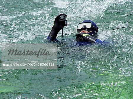 A diver diving in the icy lake