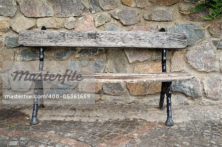 park bench against the stone wall