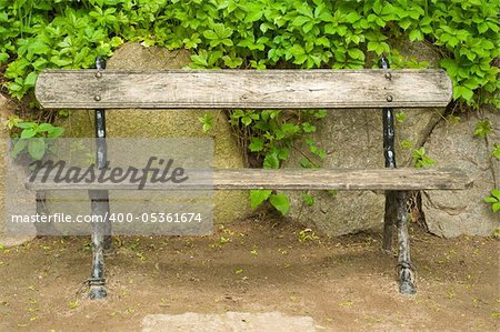park bench against the stone wall
