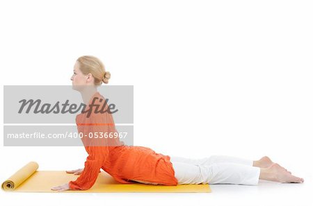 series or yoga photos. young woman in cobra pose on yellow pilates mat