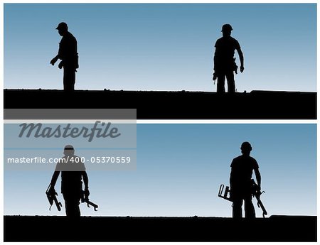 Construction workers work on building site.