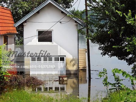 house surrounded by water in river during spring flood in Serbia