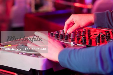 Dj playing the track in the nightclub at a party