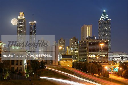 Skyline of downtown Atlanta, Georgia from above Freedom Parkway with a full moon.