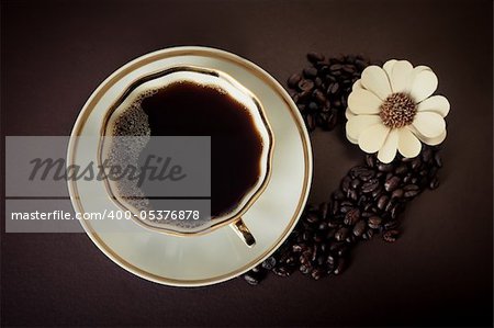 A cup of coffee with beans