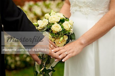 bride and groom holding hands