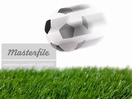 Black and white soccer balls isolated on artificial grass