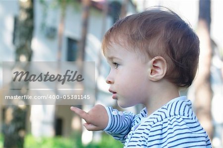 Close-up portrait of a pointing baby a the park