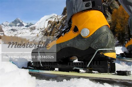 Close up to the ski boot with view towards the mountains