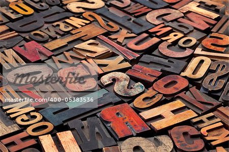 antique wood letterpress printing blocks with color ink patina, random collection of different size and style