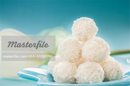 Arrangement of coconut cookies on blue background.