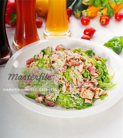 fresh classic caesar salad with red and blonde beer on background ,healthy meal