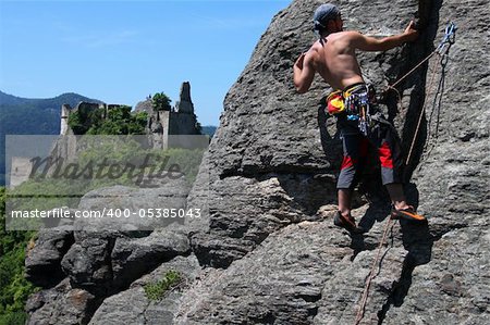 Climber  on a granite wall with landscape view