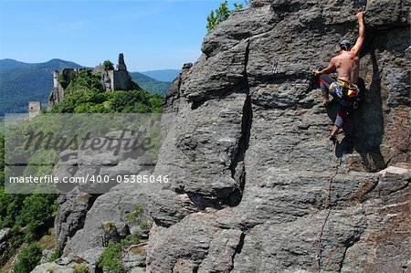 Male rock-climber  on a granite wall with magnificent view