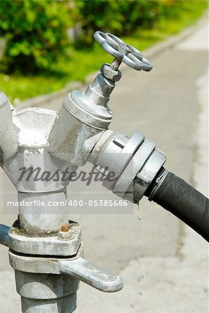 metallic hydrant details closeup outdoor, water drops