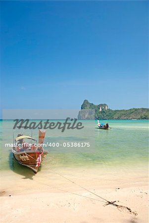 boat on tropical ko phi phi beach in thailand