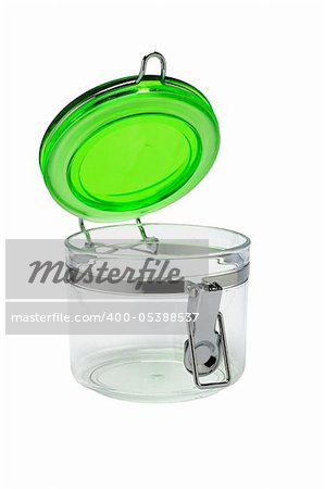 Open glass container with green plastic lid on white background