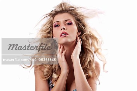portrait of a sensual girl with her hair flying in the wind posing on white