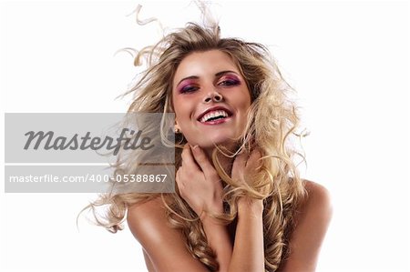 face shot of a laughing curly blonde throwing her hair in the wind