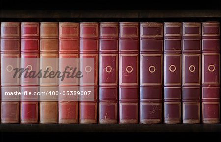 Vintage books in different shades of red and brown in bookcase