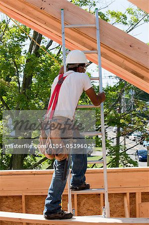Carpenter climbing a ladder