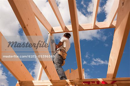 Carpenter adjusting roof rafters