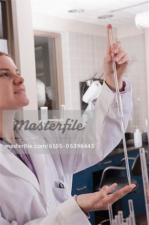 Scientist holding a pipette in the laboratory of water treatment plant