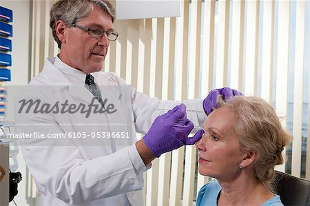 Ophthalmologist giving a Botox injection to a patient