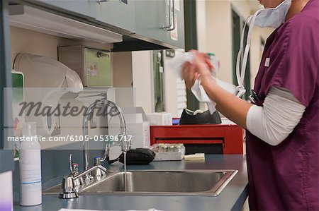 Female nurse wiping her hands after wash