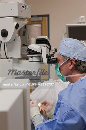 Doctor using a hand piece for irrigation during cataract surgery