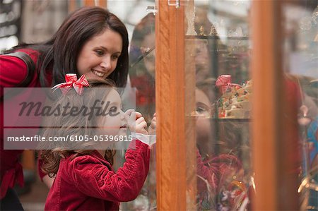 Woman window shopping with her daughter