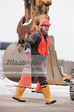 Transportation engineer moving traffic cones at a construction site