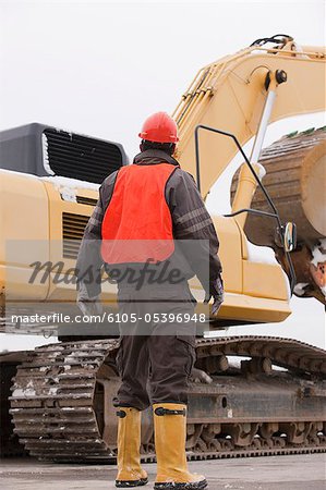 Transportation engineer directing an earth mover at a construction site