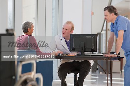 Doctor and male nurse consulting with a patient
