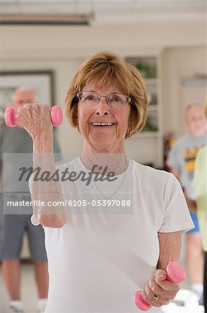 Woman exercising with dumbbells in a health club