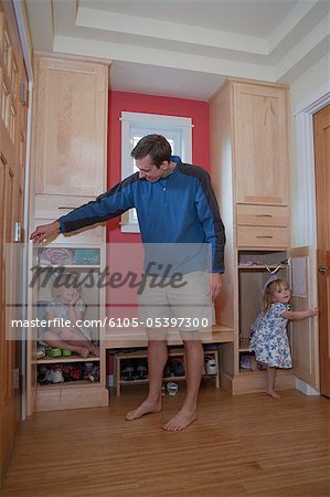 Girls playing with their father in a disability accessible home