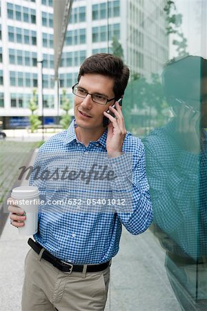 Man talking on cell phone while on coffee break