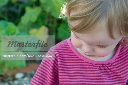 Toddler girl looking down