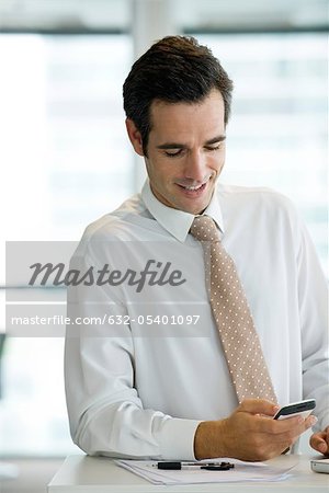 Businessman text messaging