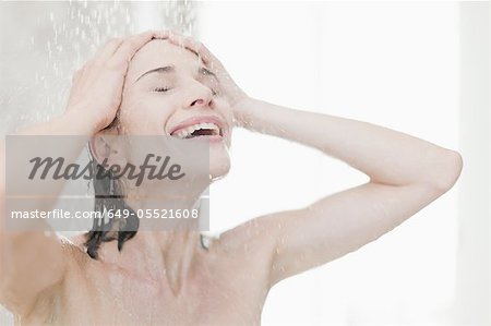 Smiling woman taking shower