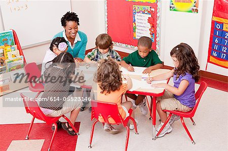 Teacher and children in school art class