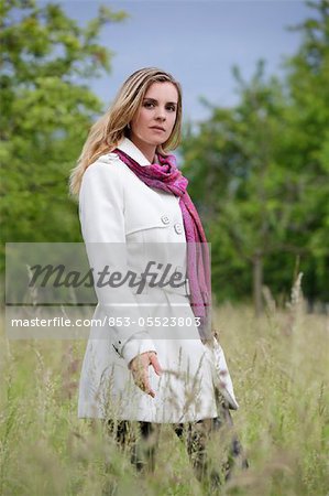 Young woman in white trench coat