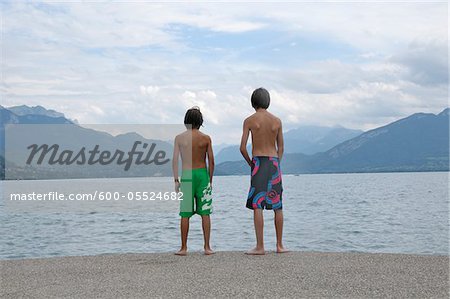 Back View of Boys Standing on Shore of Lake, Annecy, Alps, France