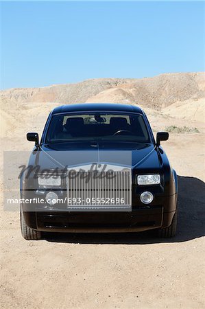 Front view of Rolls Royce parked on unpaved road