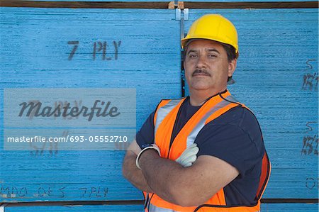 Portrait of a warehouse worker with arms crossed