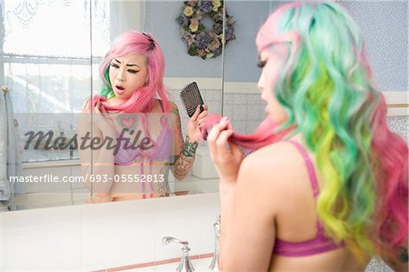 Unhappy woman looking at her hair