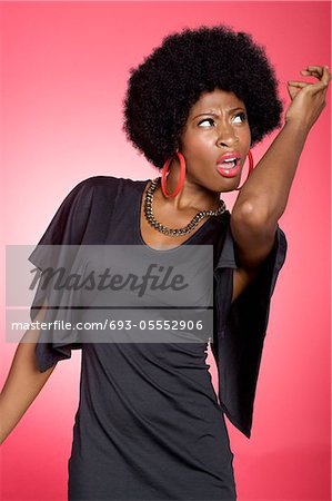 Dancing young woman over colored background
